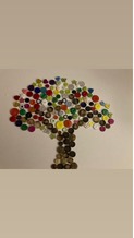A tree collage made from brightly coloured buttons on canvas