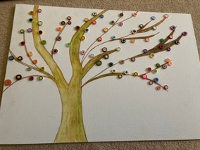 A painted tree on canvas with coloured buttons forming blossom along its branches
